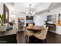Cozy dining area featuring a modern chandelier, and views into the adjacent kitchen at 3031 N Civic Center Plz # 340, Scottsdale, AZ 85251