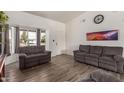Bright living room featuring wood floors, neutral walls, and comfortable couches at 3144 S Rogers --, Mesa, AZ 85202