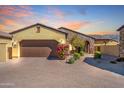 Exterior of home with two-car garage, stone accents, desert landscaping, and walkway at 3171 S Hawthorn Ct, Gold Canyon, AZ 85118