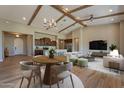 Spacious living room with wooden beams, hardwood floors, and an open floor plan to the kitchen at 3171 S Hawthorn Ct, Gold Canyon, AZ 85118