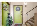 Inviting entryway features decorative wreaths and welcome sign by the front door at 349 E Thomas Rd # E401, Phoenix, AZ 85012