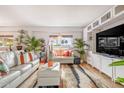Cozy living room with palm tree views, tiled floors, and stylish decor at 349 E Thomas Rd # E401, Phoenix, AZ 85012