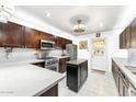 Modern kitchen with stainless steel appliances, white tile backsplash, quartz countertops, and a functional island at 4008 W Citrus Way, Phoenix, AZ 85019
