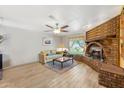 Inviting living room featuring a unique brick fireplace and views of the yard at 4008 W Citrus Way, Phoenix, AZ 85019