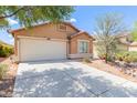 Single-story home featuring a two-car garage and desert landscaping at 41373 W Coltin Way, Maricopa, AZ 85138