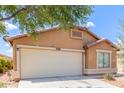 Single-story house featuring a two-car garage and desert landscaping at 41373 W Coltin Way, Maricopa, AZ 85138