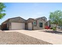 Attractive home featuring desert landscaping, a two-car garage and separate one-car garage at 4671 N 185Th Ln, Goodyear, AZ 85395