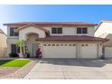 Charming two-story home with a three-car garage, desert landscaping, and a red tile roof at 5754 W Larkspur Dr, Glendale, AZ 85304