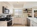 Bright kitchen features white cabinets, stainless steel appliances, and a modern countertop at 6005 N Granite Reef Rd, Scottsdale, AZ 85250
