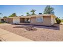 Inviting single-story home with a desert landscape and a covered porch entrance, exuding curb appeal at 720 S Rosemont --, Mesa, AZ 85206