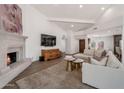 Comfortable living space with stylish fireplace, modern TV, and cohesive design elements for relaxation at 8719 E San Marino Dr, Scottsdale, AZ 85258