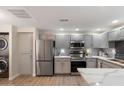 Bright kitchen showcasing stainless steel appliances, light countertops, and wood-look flooring at 9555 E Raintree Dr # 1055, Scottsdale, AZ 85260