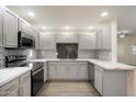 Fully renovated kitchen features recessed lighting, gray cabinets, stainless steel appliances, and marbled countertops at 9555 E Raintree Dr # 1055, Scottsdale, AZ 85260