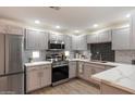 Updated kitchen featuring stainless steel appliances, tile backsplash, and painted cabinets at 9555 E Raintree Dr # 1055, Scottsdale, AZ 85260