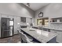 Modern kitchen with a large island, stainless steel appliances, and white cabinets at 9736 E Ironwood Dr, Scottsdale, AZ 85258