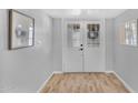 The entrance features a double door and beautiful flooring that leads into the home at 10743 W Frier Dr, Glendale, AZ 85307
