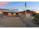 Exterior of home with desert landscaping, American flag, and covered front entry at 10743 W Frier Dr, Glendale, AZ 85307