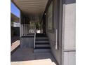 Charming single-story home featuring a covered entryway and gray siding at 11411 N 91St Ave # 75, Peoria, AZ 85345