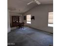 Bright living room with vaulted ceilings, blue carpet and traditional dining area at 11411 N 91St Ave # 75, Peoria, AZ 85345