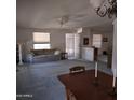 Open-concept living space featuring carpet, multiple entrances, and ample natural light at 11411 N 91St Ave # 75, Peoria, AZ 85345