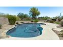 Backyard kidney-shaped pool with a desert landscape and pebble rock at 1532 W Glenhaven Dr, Phoenix, AZ 85045