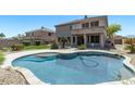 Inviting backyard pool and patio area with a two-story home in the background at 1532 W Glenhaven Dr, Phoenix, AZ 85045
