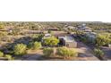 Desert home showcasing charming landscaping, neutral tones, and a tile roof for a serene, natural aesthetic at 30813 N 138Th St, Scottsdale, AZ 85262