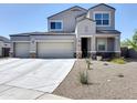 Charming two-story home with a three car garage, easy care landscaping and modern architectural details at 31077 W Cheery Lynn Rd, Buckeye, AZ 85396