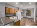 Bright kitchen features wood cabinets, white appliances and breakfast nook at 3709 E Woodside Way, Gilbert, AZ 85297