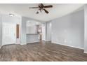 Open living room with wood-look floors, ceiling fan, and entry to kitchen at 3709 E Woodside Way, Gilbert, AZ 85297