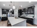 Contemporary kitchen showcasing dark cabinets, stainless steel appliances, and a bright white quartz island at 3933 E Alfalfa Dr, Gilbert, AZ 85298