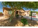 View of front of single-story house with beige stucco, red-tiled roof, and xeriscaped yard at 44188 W Cydnee Dr, Maricopa, AZ 85138