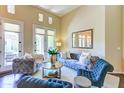 Bright living room with plush seating, a decorative mirror, and access to outdoor patio through French doors at 8905 E Mountain Spring Rd, Scottsdale, AZ 85255