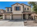 Charming two-story home featuring a spacious three-car garage and inviting front porch at 10945 E Storia Ave, Mesa, AZ 85212