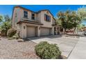 Spacious two-story home with a three-car garage, inviting porch, and manicured landscaping at 10945 E Storia Ave, Mesa, AZ 85212