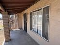 Exterior front porch showcasing a secure metal door and a large window at 112 S 28Th Dr, Phoenix, AZ 85009