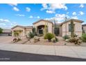 Tan single-story home with well-manicured desert landscaping and a tile roof at 11448 E Blue Sky Dr, Scottsdale, AZ 85262