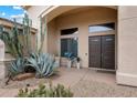 Inviting front entrance with desert landscaping and a modern front door at 11448 E Blue Sky Dr, Scottsdale, AZ 85262