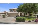 Two-story home with a two car garage, manicured lawn, and desert landscaping at 119 S Monterey St, Gilbert, AZ 85233
