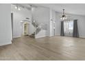 Spacious living room with wood look tile flooring and staircase at 119 S Monterey St, Gilbert, AZ 85233