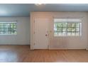 Open-concept living room featuring laminate flooring and natural light at 13261 N 110Th Ave, Sun City, AZ 85351