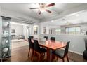 Dining room showcasing hardwood floors, modern furniture, a large mirror, and views to other living spaces at 14921 W Luna S Dr, Litchfield Park, AZ 85340