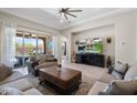 Open-concept living room with comfortable sofas, tile flooring, and a view of the backyard at 15663 S 183Rd Dr, Goodyear, AZ 85338