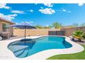 Backyard pool with a clean patio, beautiful blue water, and outdoor umbrella providing shade at 15663 S 183Rd Dr, Goodyear, AZ 85338