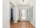 Bright entryway features a white front door with sidelights and beautiful hardwood flooring at 15825 N 45Th St, Phoenix, AZ 85032
