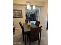Inviting dining area with a contemporary light fixture and room with decorative sunflowers centerpiece on the table at 17823 N 99Th Dr, Sun City, AZ 85373