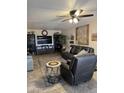 Comfortable living room featuring a ceiling fan, modern furniture, and television for entertaining guests at 17823 N 99Th Dr, Sun City, AZ 85373