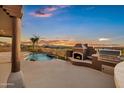 Outdoor entertaining area with a beautiful pool, grill and fireplace overlooking the sunset view at 18401 N 14Th St, Phoenix, AZ 85022