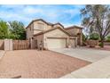Spacious two-story home featuring a three-car garage and desert landscaping at 21373 N 94Th Ave, Peoria, AZ 85382