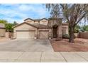 Inviting two-story home with a three-car garage and well-maintained front yard at 21373 N 94Th Ave, Peoria, AZ 85382